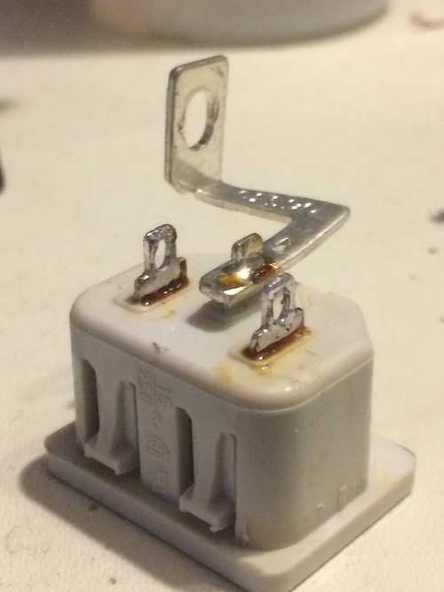 The power plug, cleaned of solder and chunks of wire