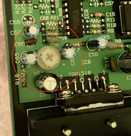 The VR1 variable resistor, which handles volume control, is circled on the board. It is topped by a white circular plastic bit with a Phillips-head adjuster, near the TDA1518 amplifier.
