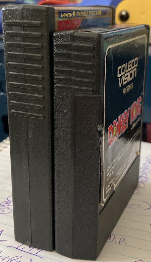 The angular view on both cartridges. The Mark III cartridge is imposingly tall compared to the Coleco one.