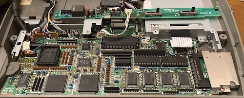 A far-away shot of the motherboard. The CPU is visible on the far left, along with a lot of QFPs