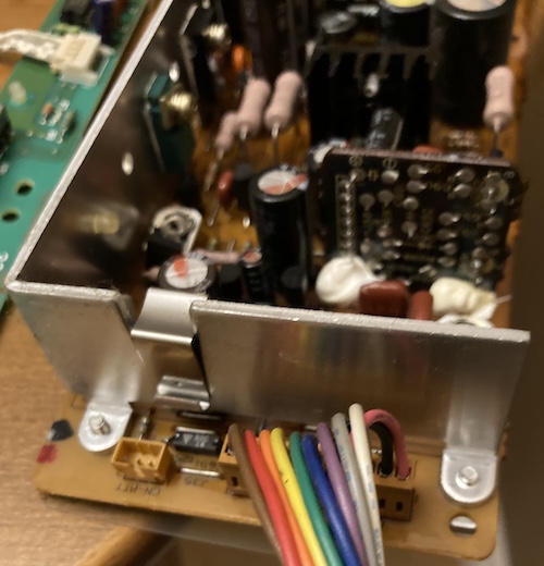 The power supply harness. A rainbow of colours is represented by surprisingly thick wires. You can also see the unplugged battery connector on the left.