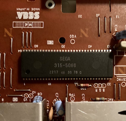 A very shaky picture of a 64-pin DIP chip reading SEGA 315-5066