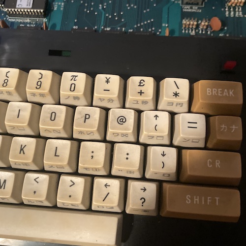 The dirty keyboard has a British pound key next to the Japanese yen key.