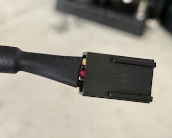 The three-pin fan connector. It has a red, black, and yellow wire.