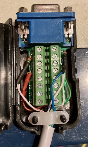 The top side of the breakout connector, with the wires inserted. You can see that the strain relief gland is not gripping the insulation of the wire, which makes it basically useless.