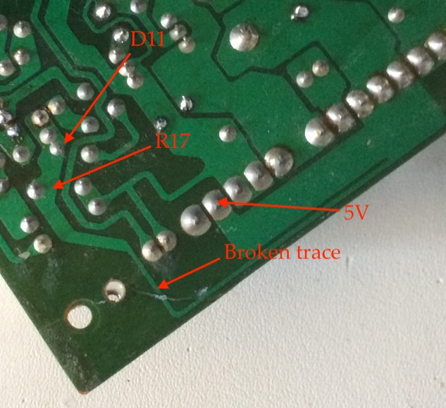 Broken corner of the board reattached, showing off the broken 5V trace