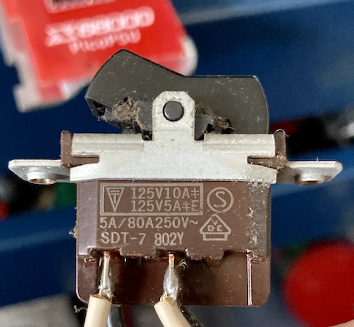 The original Alps power switch, reading 125V 10A in one configuration, 125V 5A in another, and 80A 250V in a third. Not sure what the characters mean.