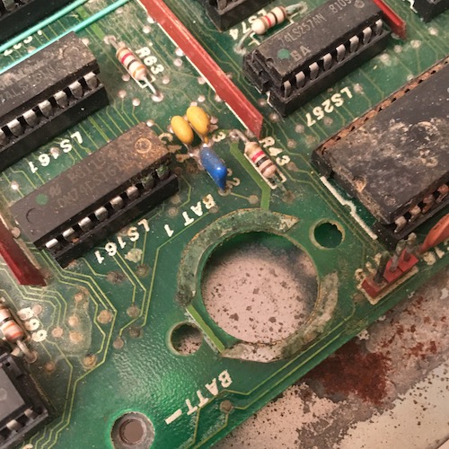 A marking "BATT" on the logic board indicates where the clock battery used to be. One of the large pours in the area has significant visible corrosion.