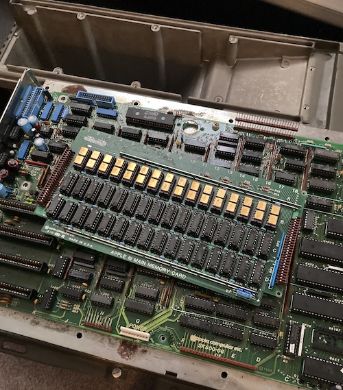 The memory board is sitting loose on top of the logic board, on top of the upturned case.