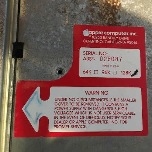 The 128K configuration is checked off, the other options being 32 and 96K. A coward's warning: Under no circumstances is the smaller cover to be removed. It contains a power supply with dangerous high voltages which is not user serviceable. In the event of difficulty, notify your dealer or Apple Computer, Inc. for prompt service.