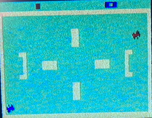 Two tanks are facing off in a pleasant aquamarine battlefield. War is hell, but the interior decoration is nice.