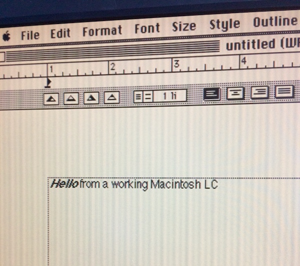 The Mac has ClarisWorks 4 open. The screen reads: Hello from a working Macintosh LC.