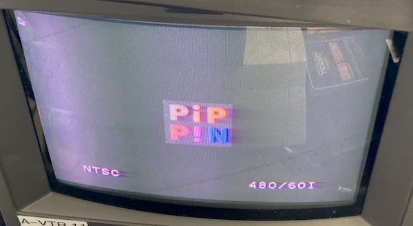 The Pippin booting. It shows the Pippin logo, along with a Macintosh mouse cursor in the top left.