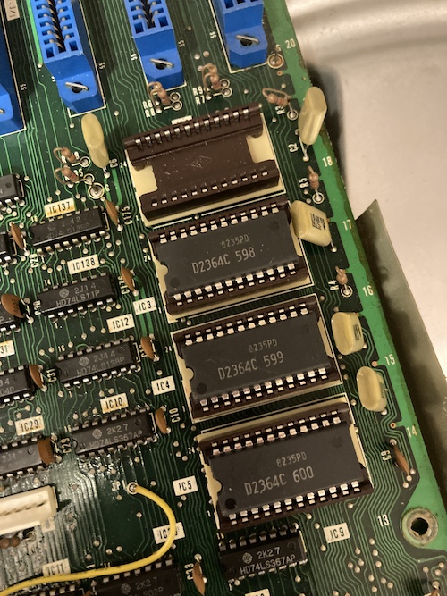 The top socket has no ROM in it, unlike the other three, which have NEC µPD2364 mask ROMs with part number 598, 599, and 600.
