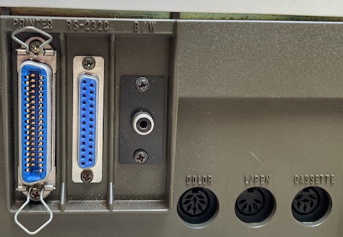 The ports on the rear. From left to right: Centronics printer, DB25 serial, RCA monochrome video, DIN8 colour video, DIN5 light pen, DIN6 cassette.