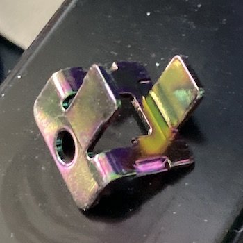 This bracket from the cartridge slot has a beautiful but deadly rainbow colour, like a trout with rabies.