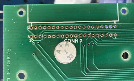 The topside of the board with the cartridge slot removed. The through-holes are intact, but some are a bit dirty.