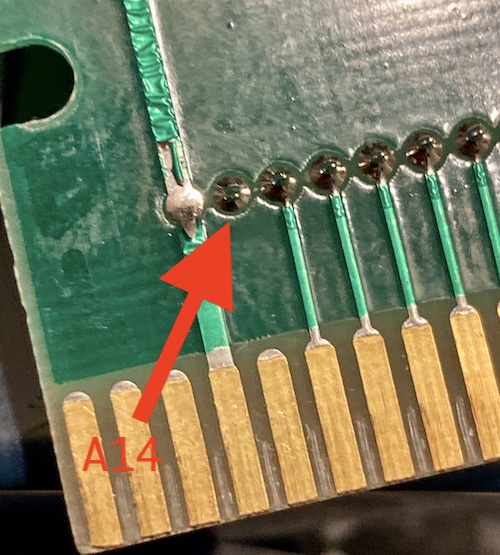 An arrow points to the A14 pin of the 27c256, which is not routed to the cartridge edge beneath.