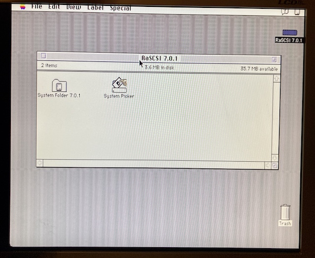 The desktop of a System 7.0.1 image on the BlueSCSI. The hard drive says "RaSCSI 7.0.1" and there is a tool called "System Picker" on the root of the drive, alongside a System Folder.
