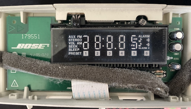 The model 179551 VFD board is exposed, with the Noritake CR1338G VFD out in front. It has templates for AUX, FM, STEREO, VOL, AM, SEEK, SLEEP, PRESET, 1-6, ALARM, ALARM 2, and the numbers.
