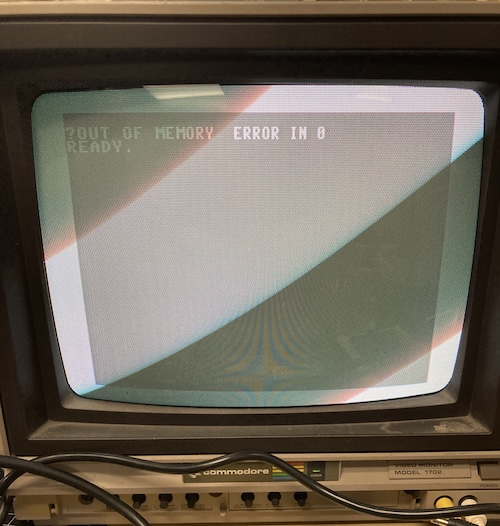 The grey-background BASIC screen reports: out of memory error in 0. Ready.
