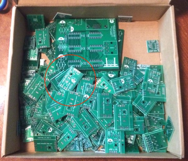 A JLCPCB box full of hundreds of very tiny circuit boards