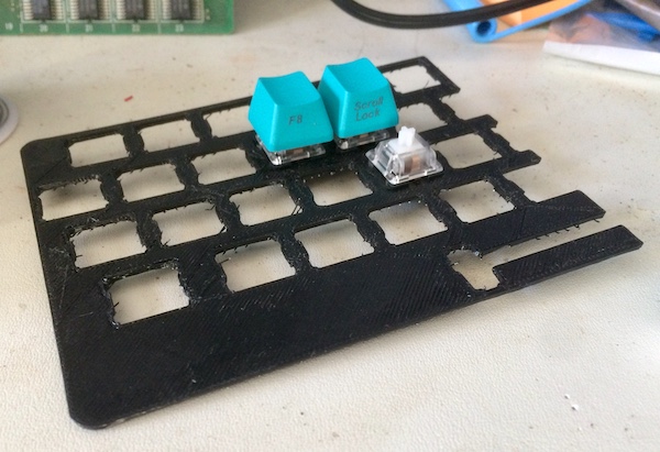 The keyboard prototype, loaded with three key switches and two key caps