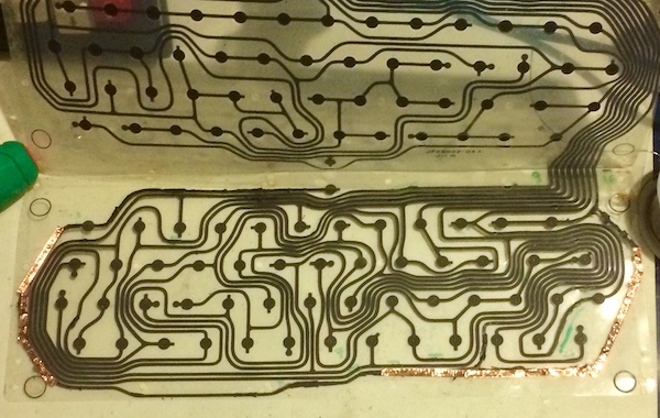 The CoCo keyboard membrane has both long curvy parts of the pin 16/space bar trace repaired with copper tape.