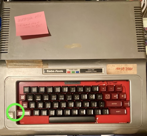 A green arrow indicates that the left shift key is fouling on the silver top case of the CoCo.