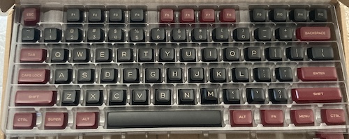 Black keycaps are surrounded by deep red accelerator keys.