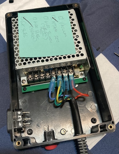The output wires are screwed onto the output terminals of the Mean Well power supply inside the enclosure. They're bunched up because I haven't pulled the cable through yet to reduce tension.