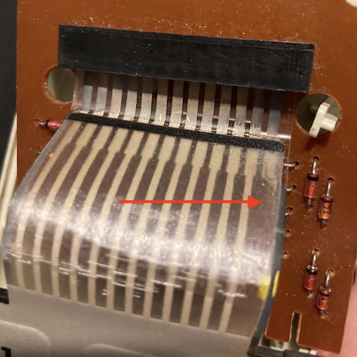 The rotted trace on the flex cable for the number pad membrane.