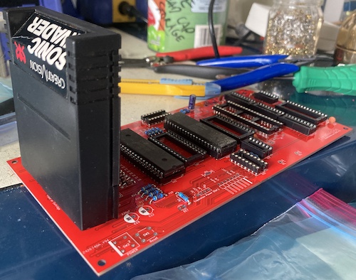 Mocking up the cart slot. A "Sonic Invaders" cartridge is sticking out of the board.