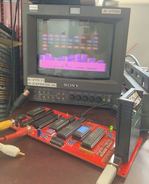 The PVM shows a purply, blurry image of Sonic Invaders playing. The Creativision PCB is in the foreground.