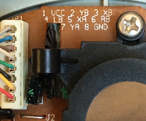 The same view, from the top: the photo-transistor is pointing at the LED, and there's an opaque black gear wheel in the way that is turned by a roller inside the mouse ball retainer.