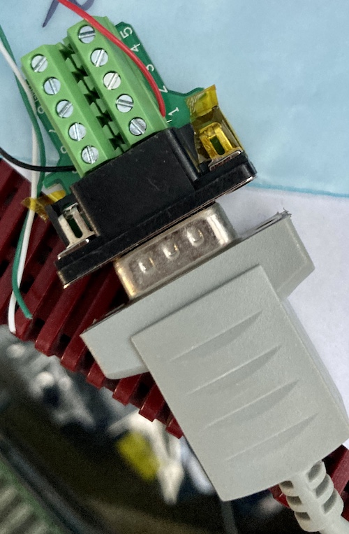 The testing harness. +5V (red) and GND (black) wires are run from a chopped-up USB cable into this DE9 breakout, which I am probing (and powering) with my Rigol oscilloscope. The mouse is plugged into the breakout so that it can be inspected.