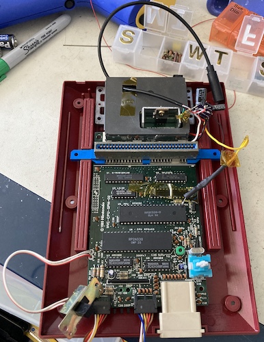 The overview of the Famicom mod as it sat at the end of the last entry. Wires are strewn everywhere and a globby board is dangling out the top.