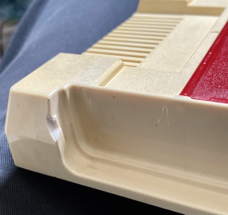 The missing chunk of plastic near the player 1 controller slot.