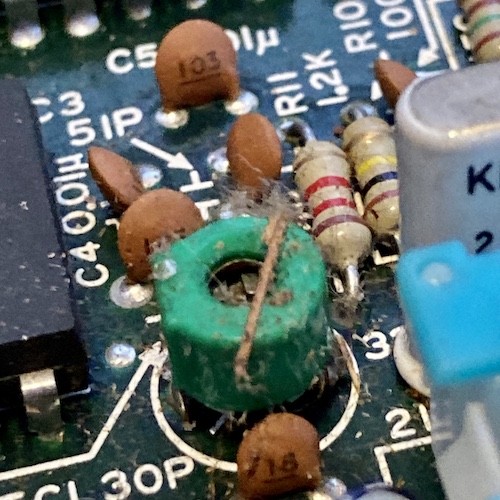 There is a green potentiometer with some gunk and tree debris (seeds?) on it.