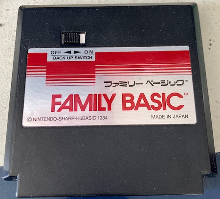 The front of the Family BASIC cartridge. It reads Family BASIC Nintendo-Sharp-HuBASIC 1984. Made in Japan. There is a switch marked "Back-up Switch" that has Off and On positions. The switch is in the off position.