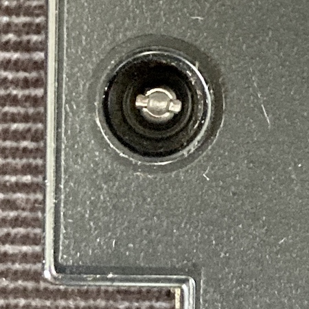 The security screw holding the bottom of the cartridge case together. It looks kind of like a circular Torx-like fastener with a flathead bit sticking out of the sides.