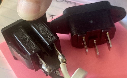 The old pass-through power connector is a lot narrower than the new IEC power connector (right.)