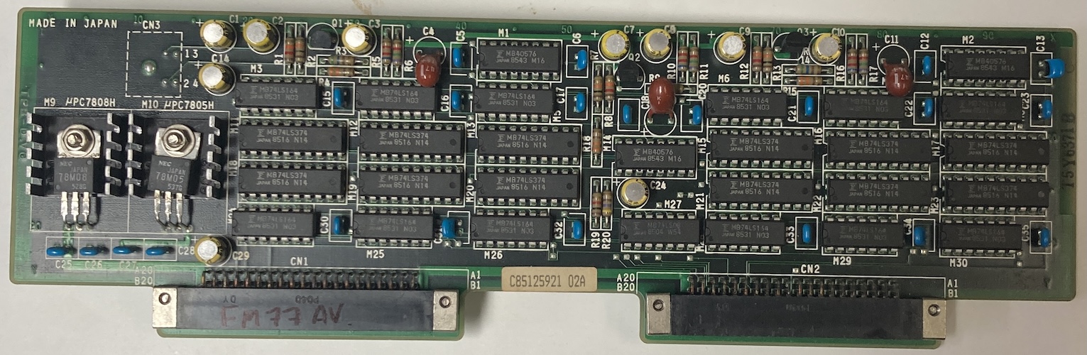 A mysterious card with two forty-pin expansion bus connectors on it. It has an 8V voltage regulator, a 5V voltage regulator, and a bunch of latches and counters.