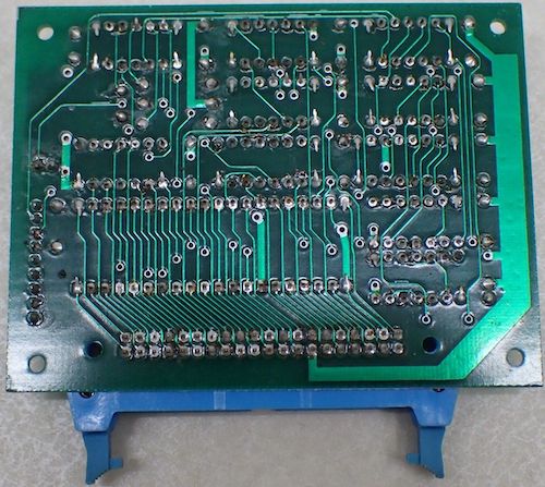 The backside of the accelerator/overclock board. It has some surprisingly big vias, and bent-over pins on many sockets, indicating it was hand-worked.