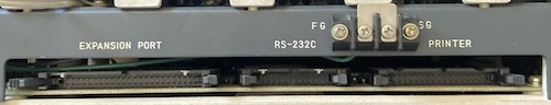 On the right side, there is a pin header for Expansion Port, RS-232C, Printer. There are screw terminals on the exterior for "FG" and "SG"