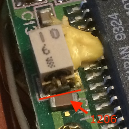 A 1206 cap lined up next to one of the 10µF electrolytics. It's just the right width to hit the two pads of the original electrolytic.