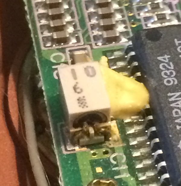 A leaky 10µF chip electrolytic cap, covered in yellowy silastic