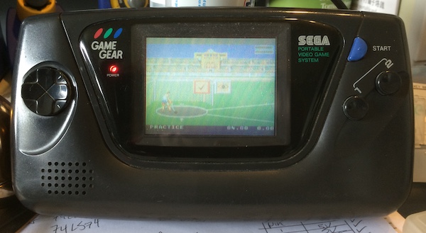 The Game Gear is working, and displays the shot-put event for Olympic Gold.