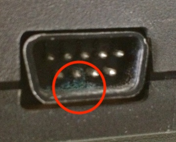 Some green detritus (circled) appears in the primary controller port.