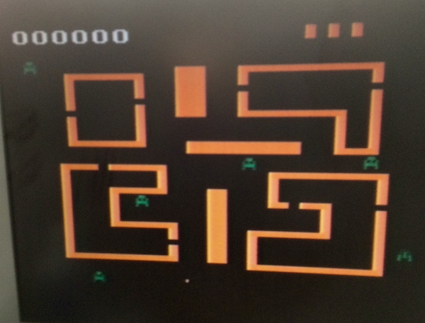 'Venture' running on the Coleco Gemini. It is an orange maze with green monsters. It looks much worse than the ColecoVision version.